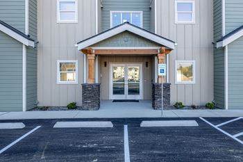 the front entrance of a building with a parking lot at Sagecrest Apartments, Wenatchee, WA, 98801